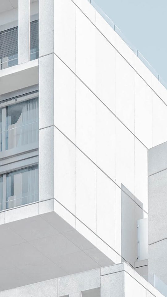 a white building with a balcony and stairs at The Discovery Park Life Apartments