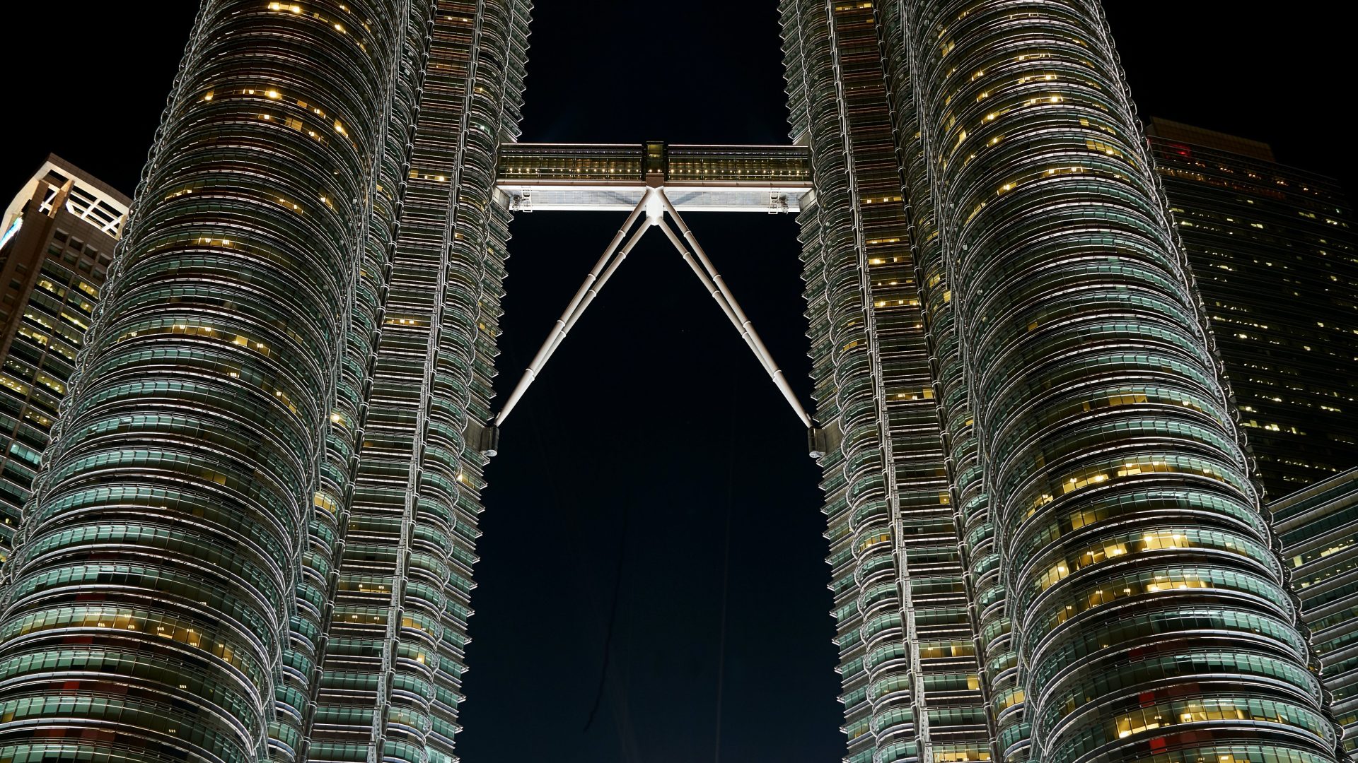 the petronas towers are lit up at night at The Discovery Park Life Apartments