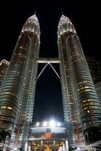 the petronas towers are lit up at night at The Discovery Park Life Apartments