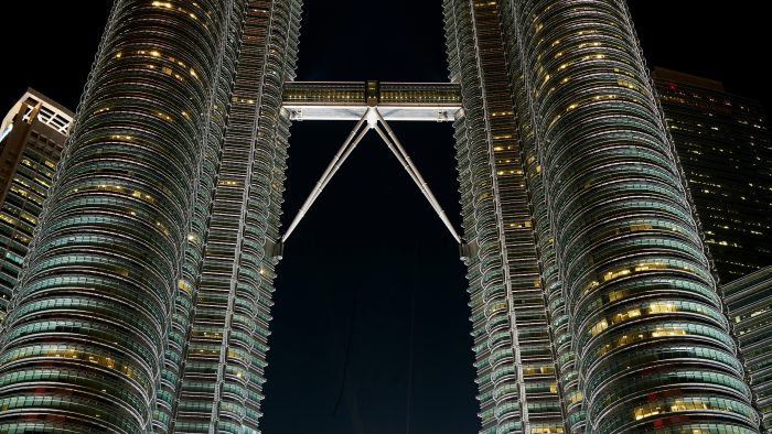 the petronas towers are lit up at night at The Discovery Park Life Apartments